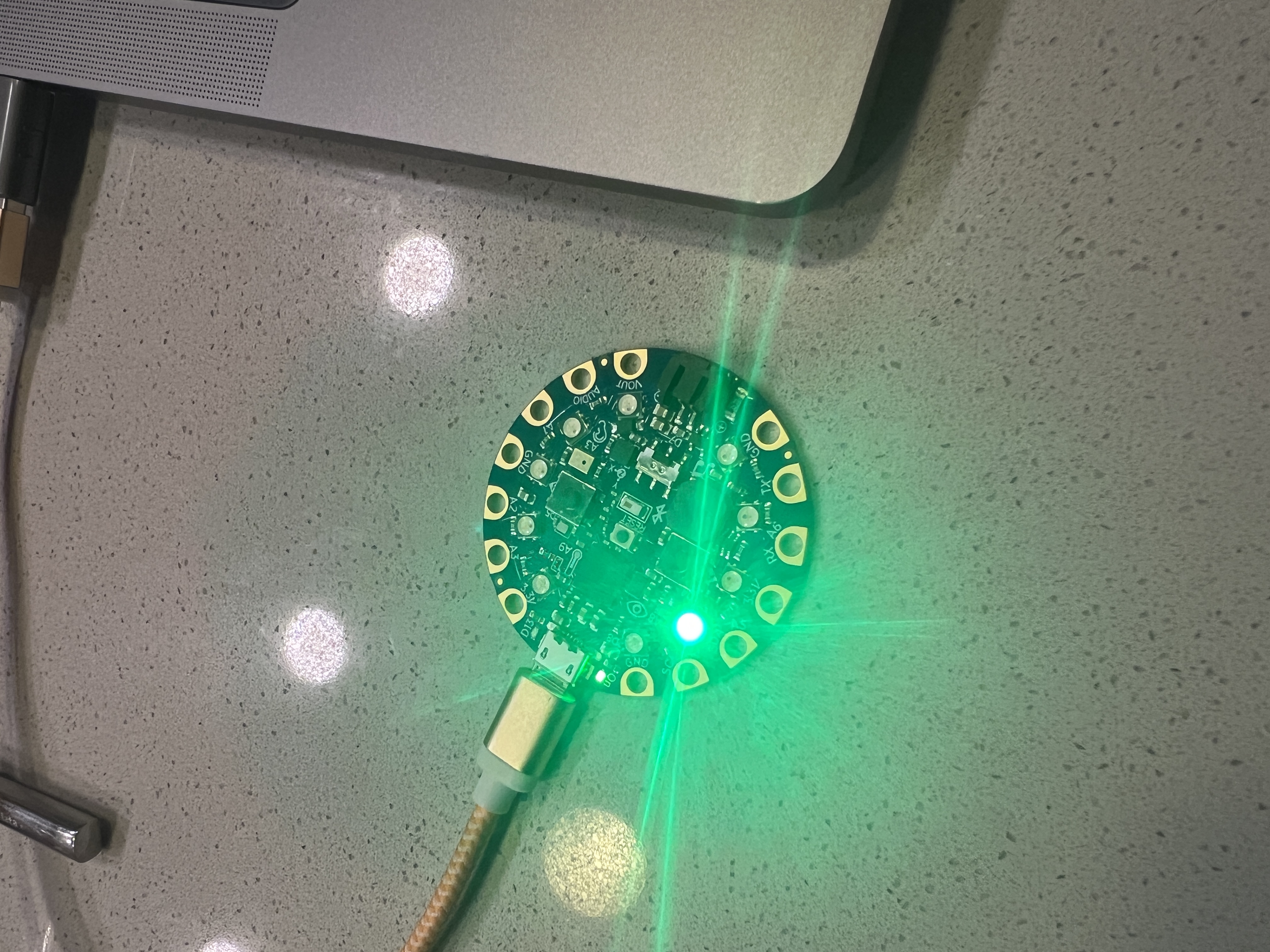 Circuit Playground microcontroller connected to a laptop